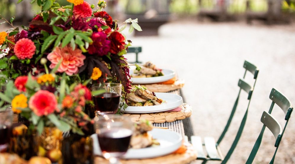 Outdoor dining table set up with flowers