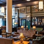 indoor lounging area with leather couches and warm lighting