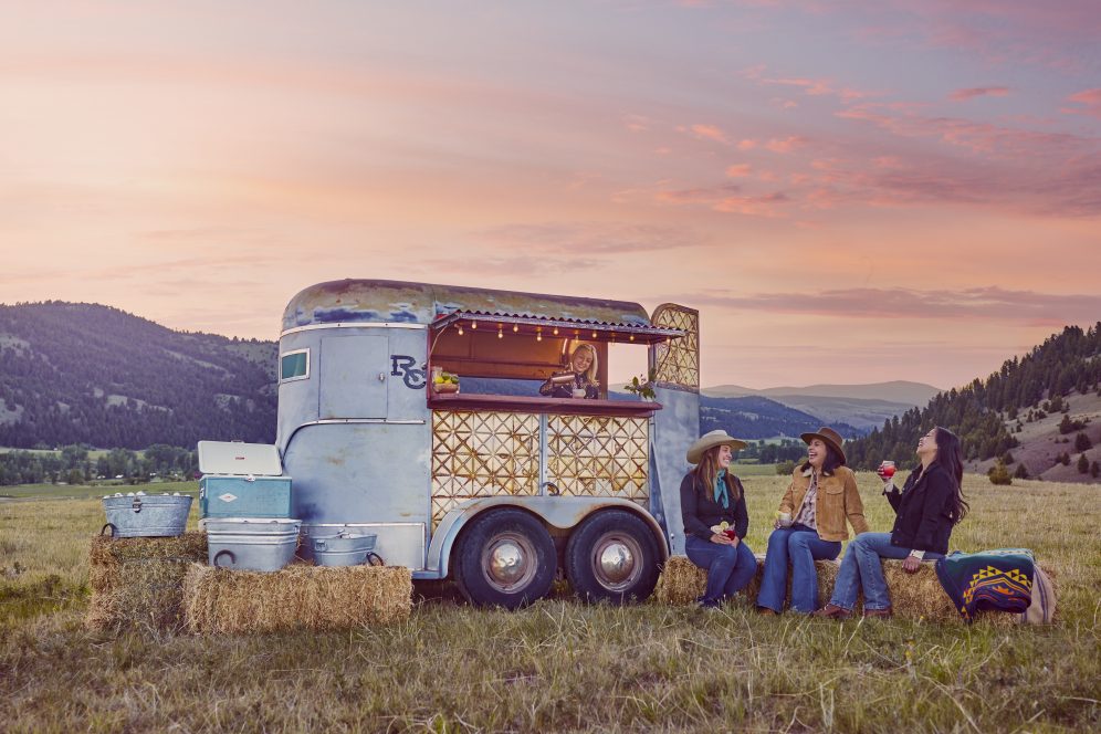 people drinking outside beside a concession